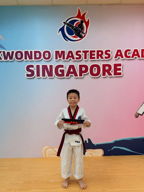 Student proudly receiving a new belt